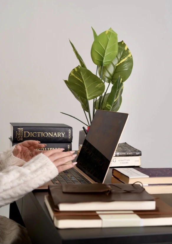 Online study at a laptop with books beside it